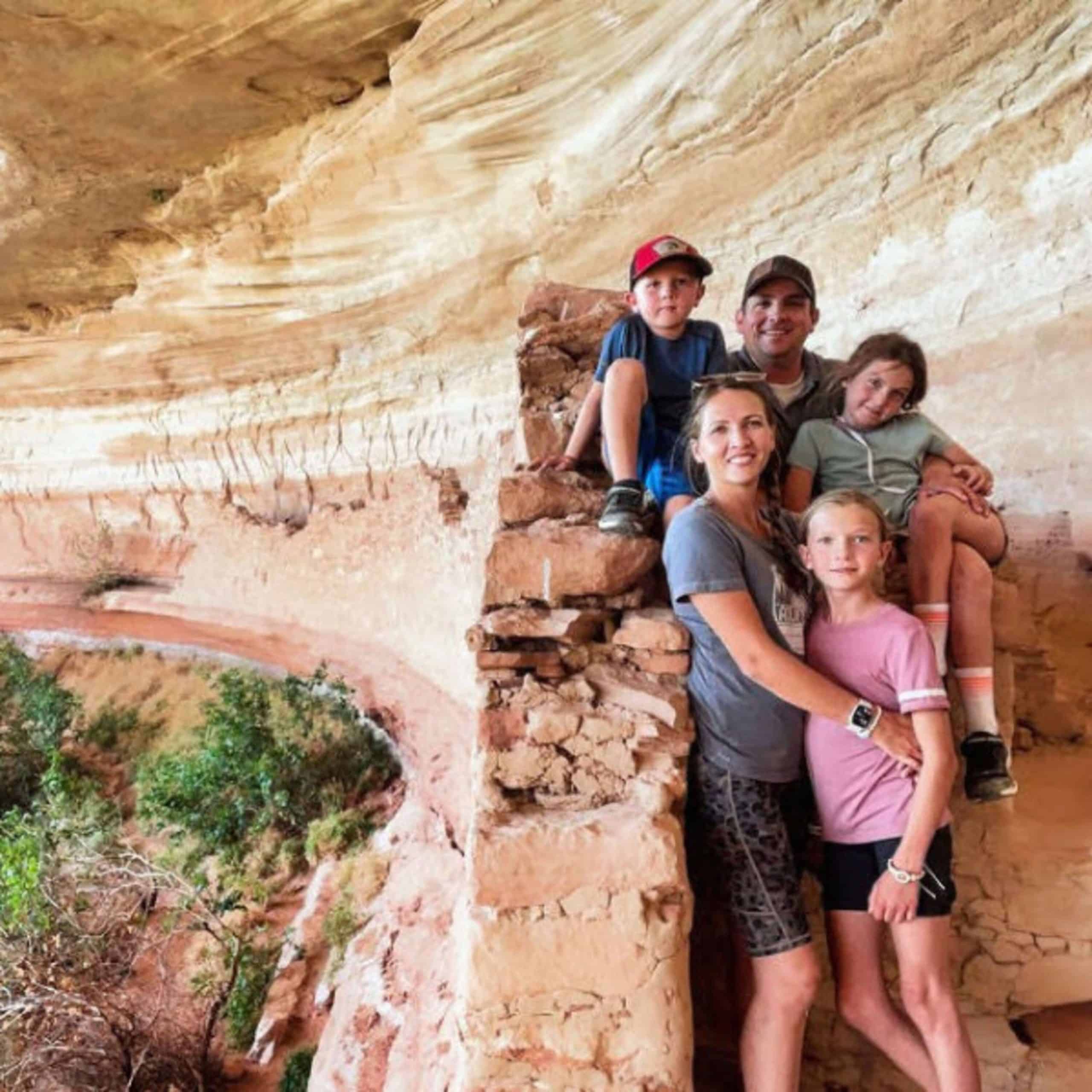 A family posing for a picture in a canyon.