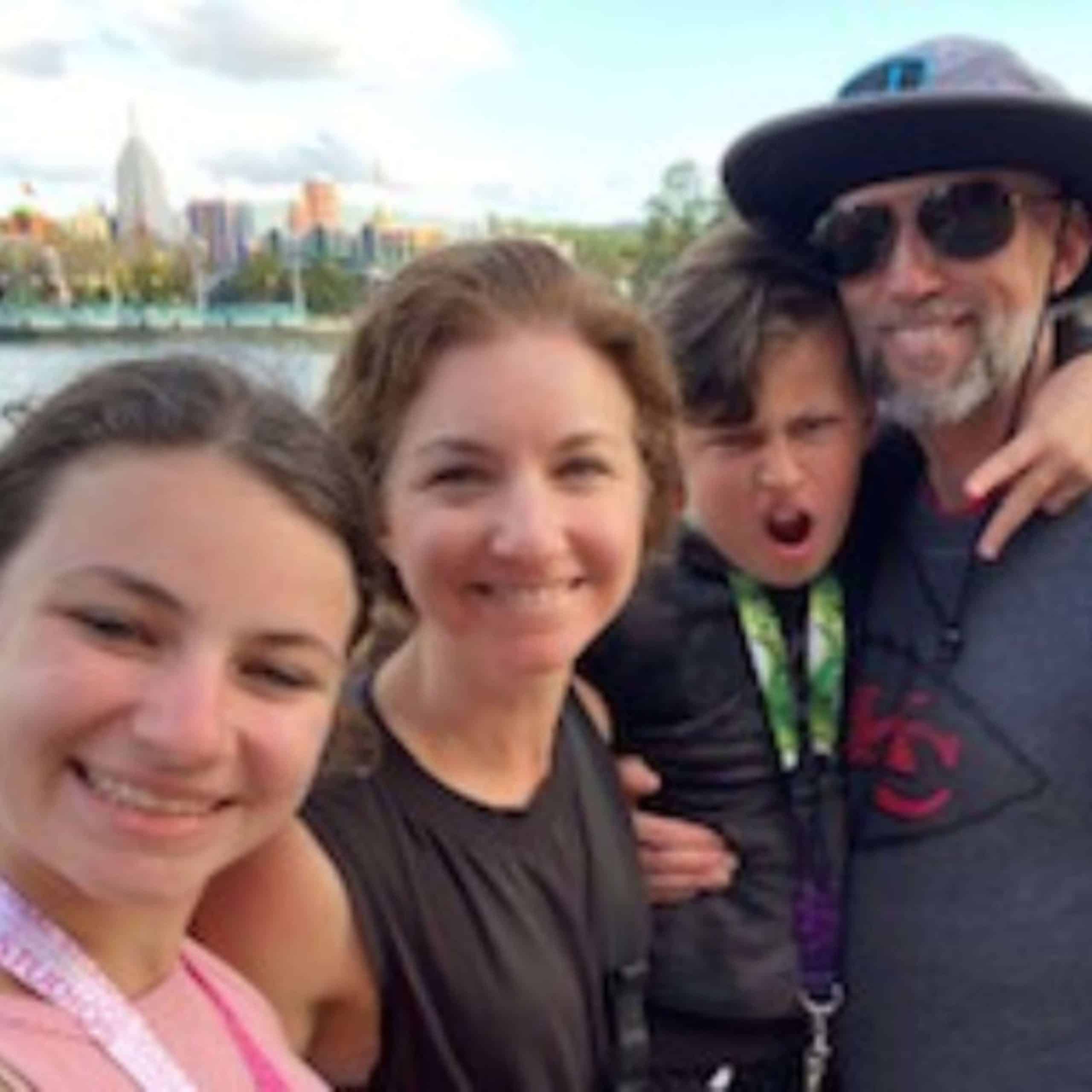 A family is posing for a photo on a boat.