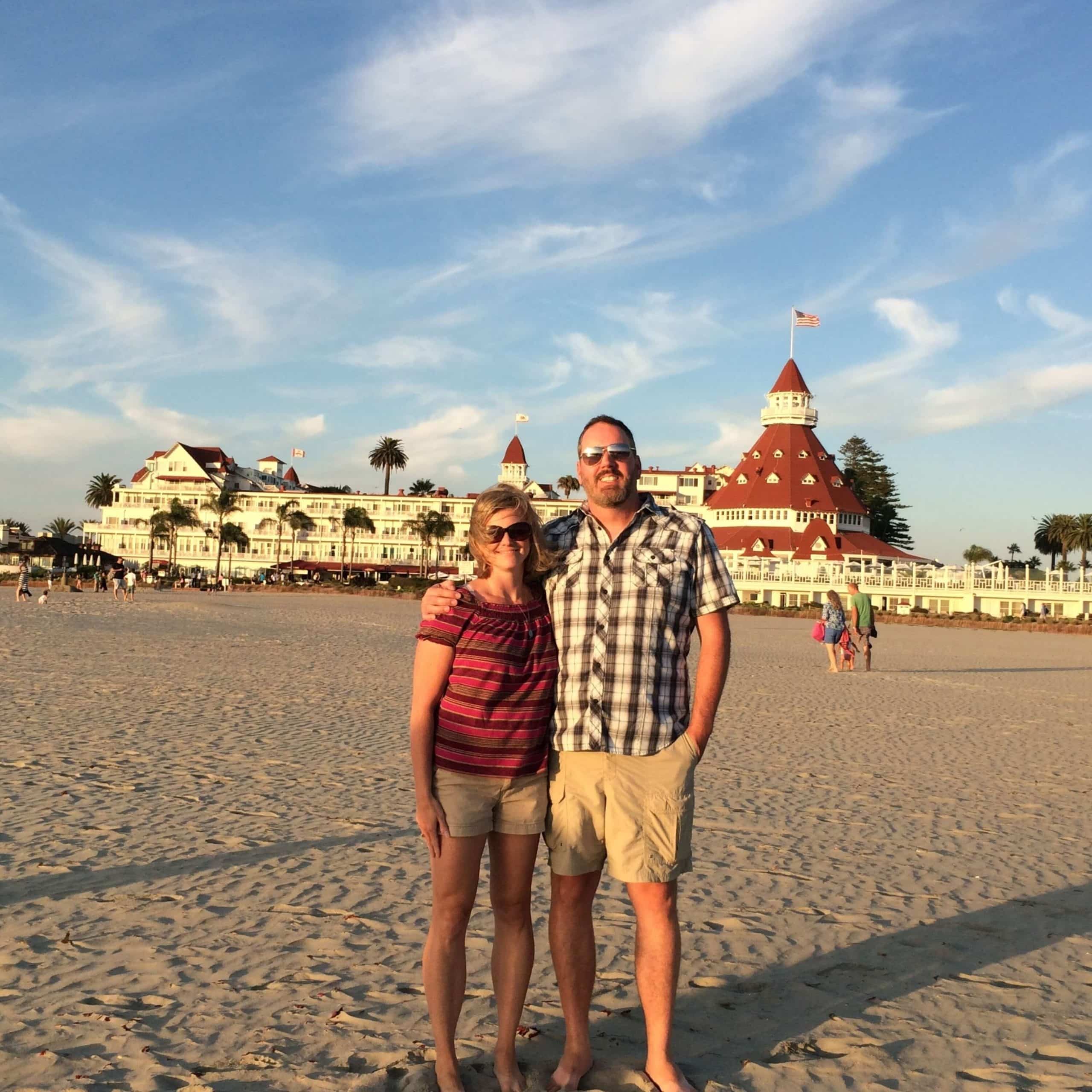 A man and woman standing on a beach.