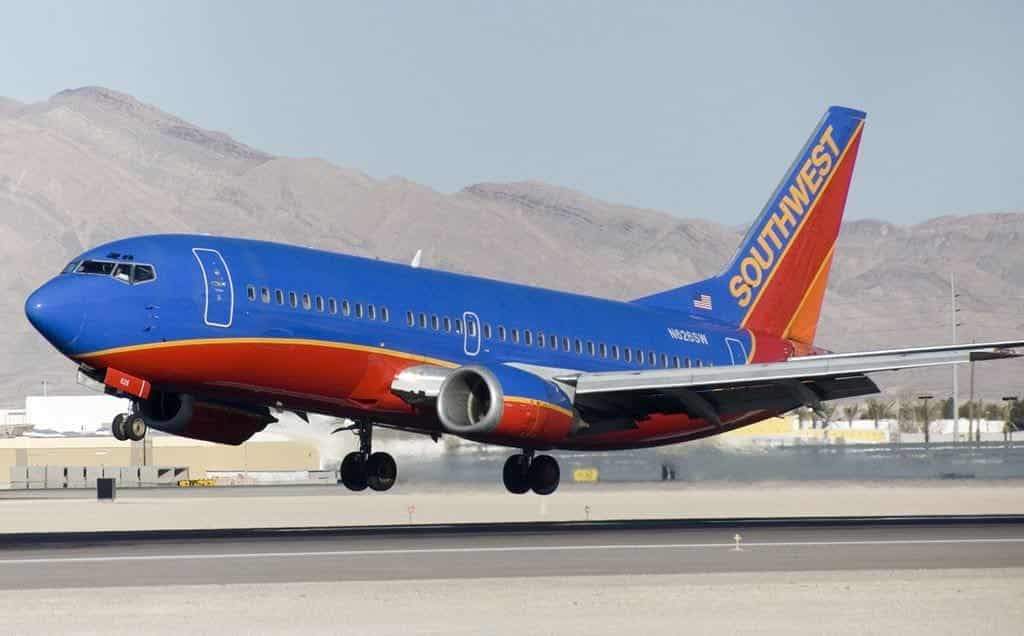 A southwest airlines plane is taking off from the runway.