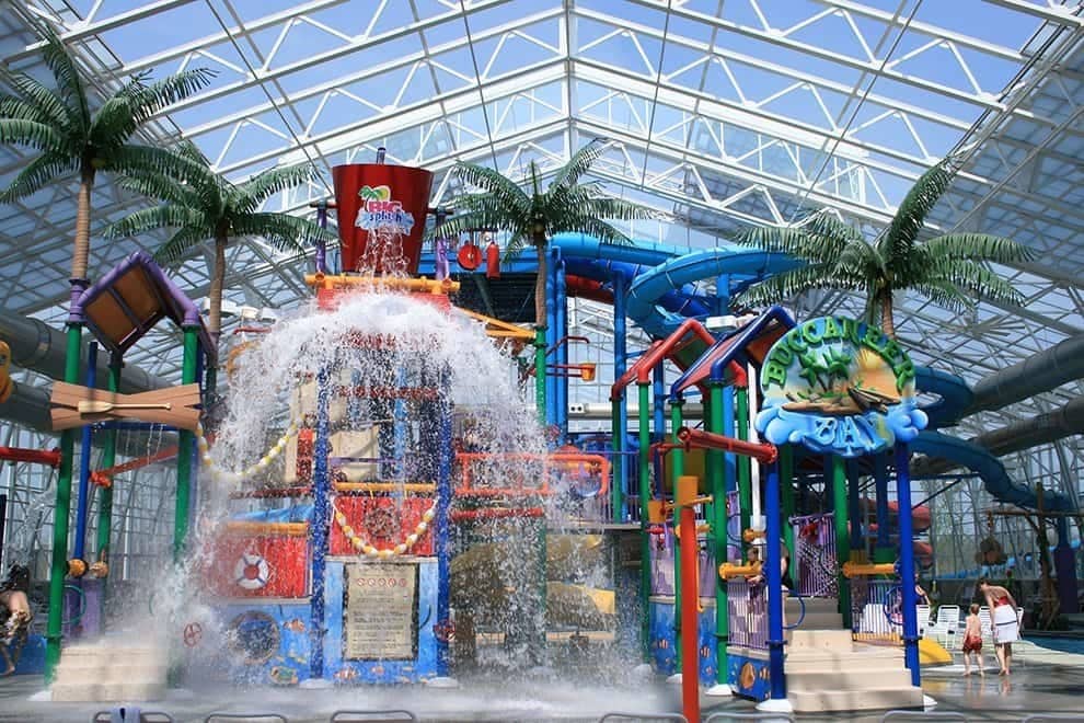 A large indoor water park with lots of water slides.