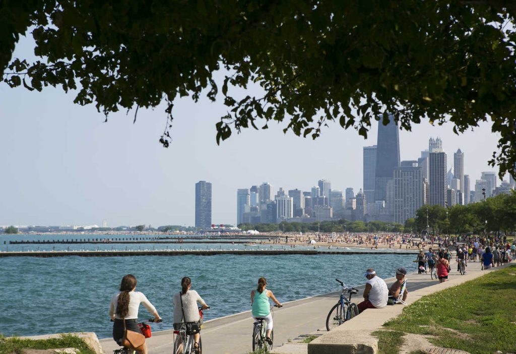 Bikers on Lake front path in Chicago with view of skyline in the background