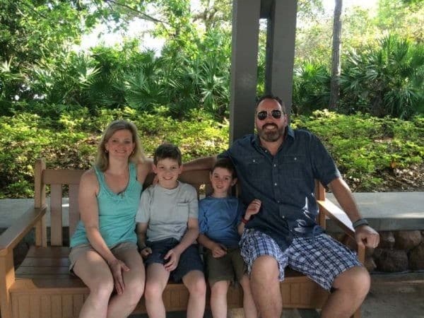 A family uncovers Disney World's secrets on a bench in a park.