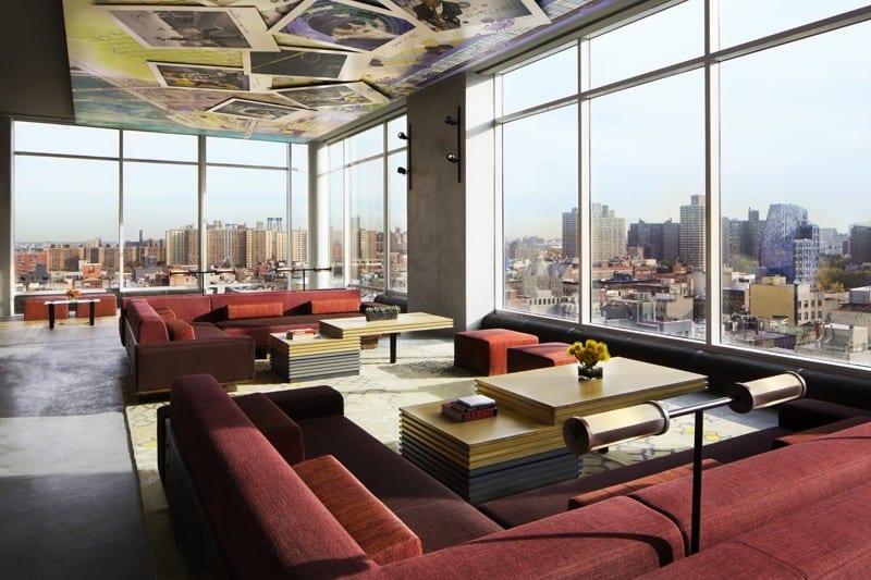 A large living room with a view of the city.