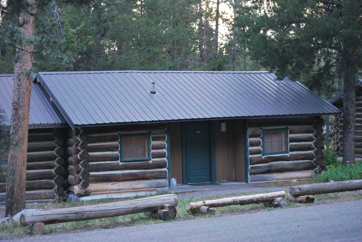 Log cabin at Colter Bay surrounded by trees.