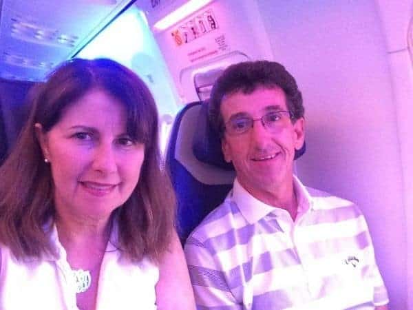 A man and a woman sitting on an airplane.