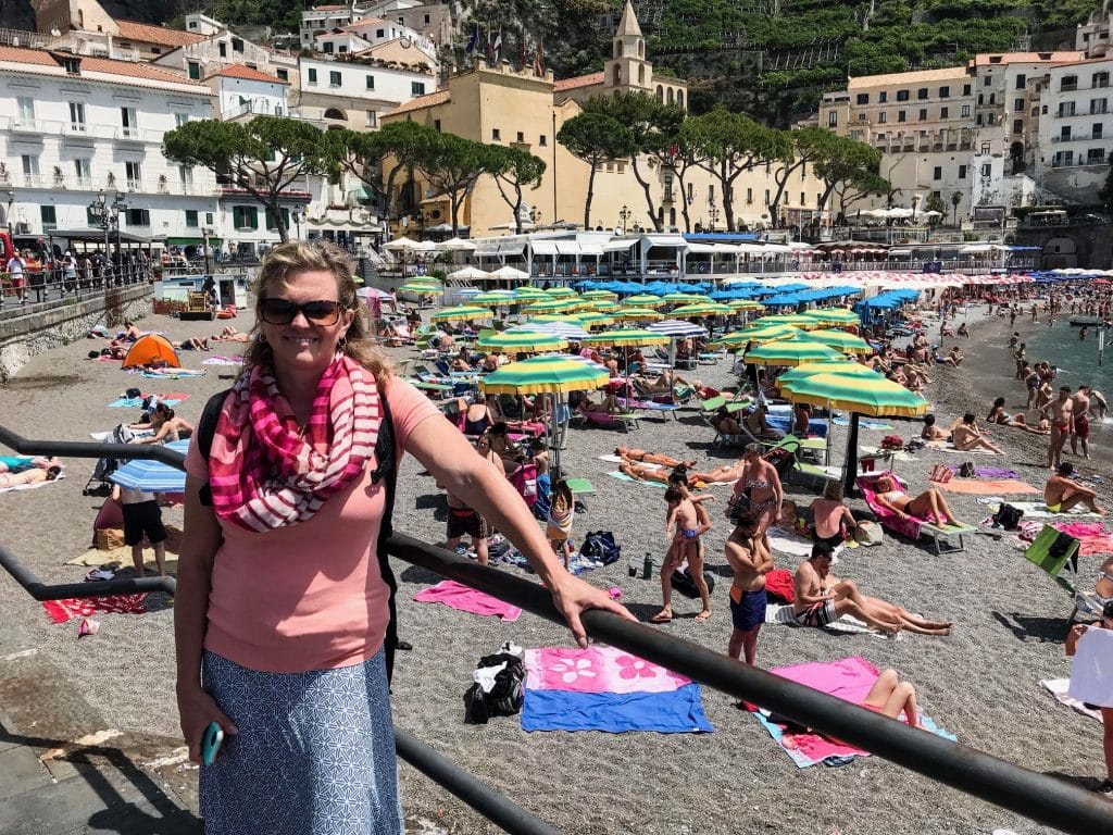 A woman enjoying Italy's breathtaking beach scenery.