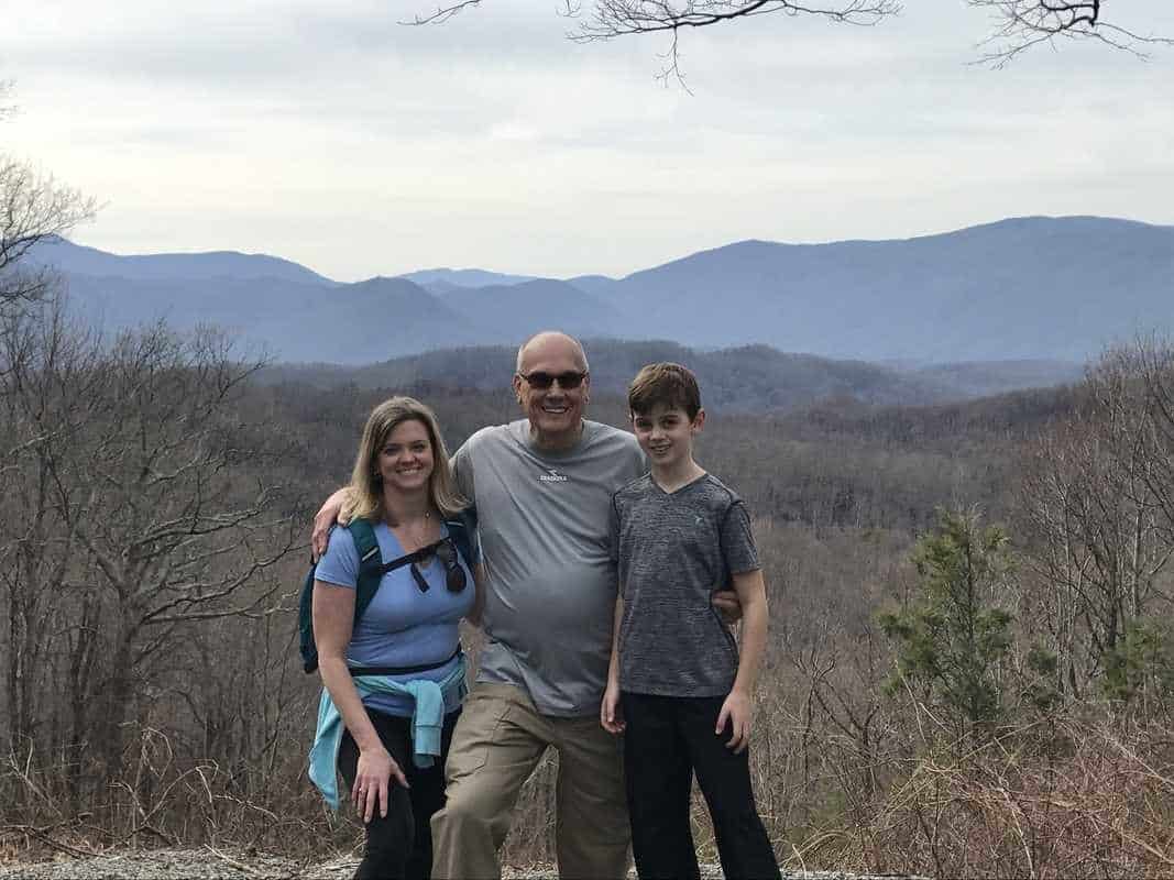 A family capturing a picture-perfect moment on a scenic mountain top in TN, one of the many unforgettable things to do in Pigeon Forge.