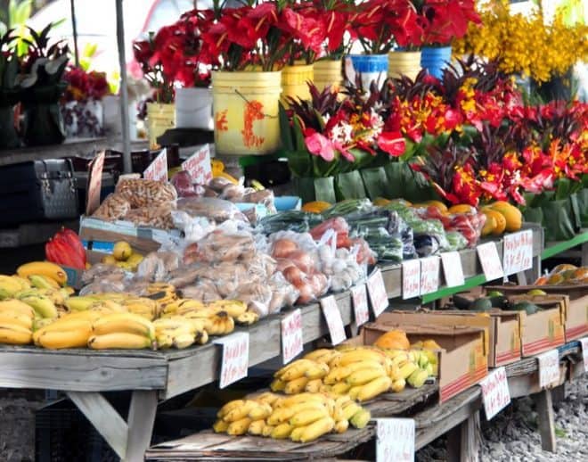 An outdoor market with a variety of fruits and vegetables.