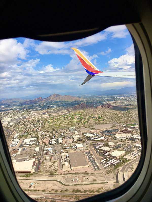 view of Southwest wing from airplane flying over Phoenix