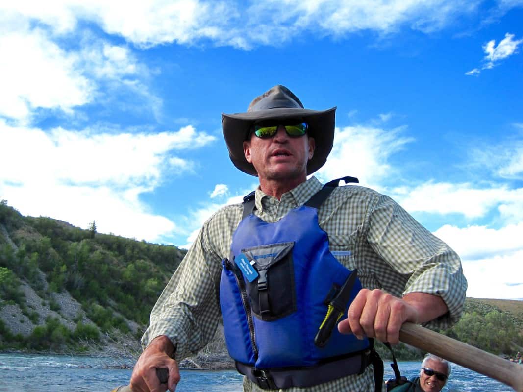 Guide on Twilight Float on the Snake River wearing sunglasses and rowing.