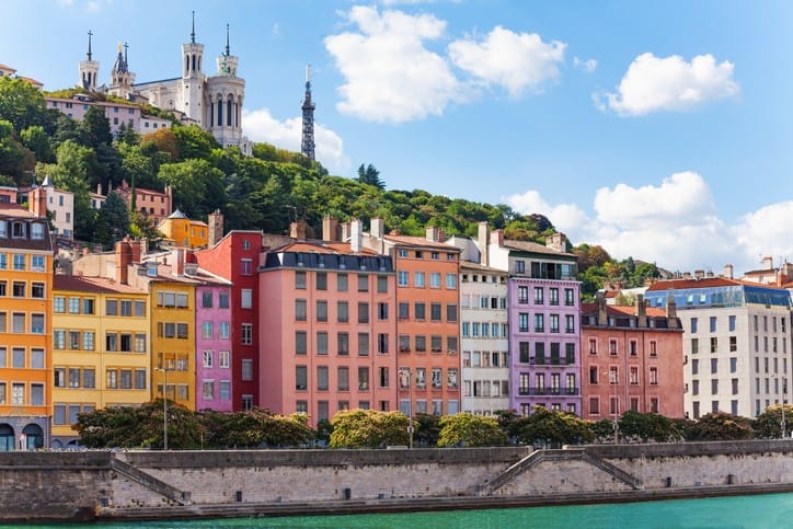 Colorful buildings on the side of a river in france.