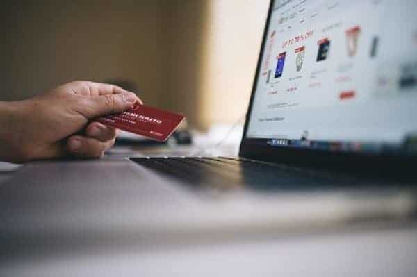 A person engaging in Rapid Rewards Shopping with a credit card on a laptop.