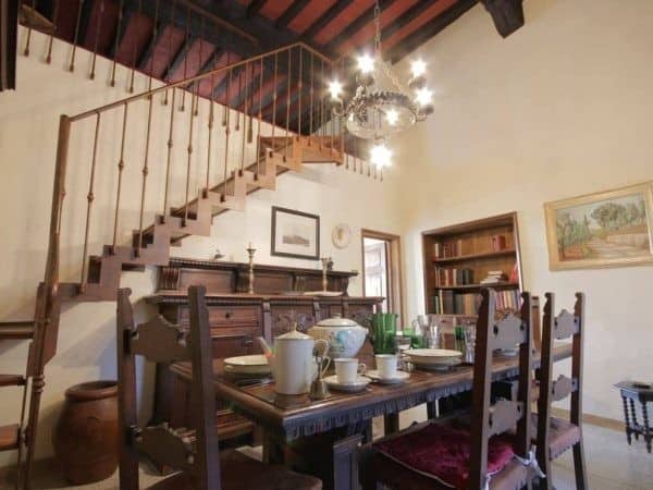 A dining room with a wooden table and chairs.