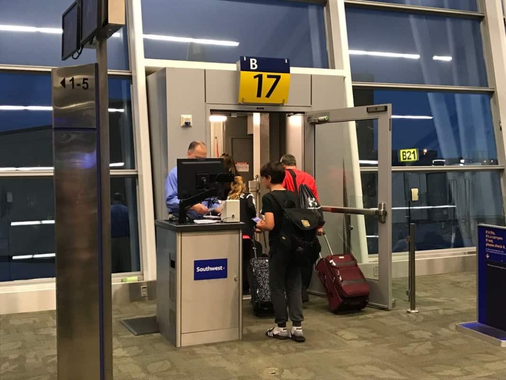 A group of people at the Southwest check-in counter in an airport.