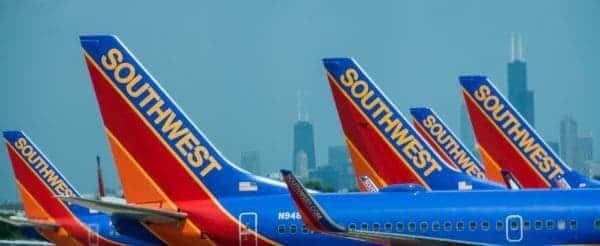 Southwest airlines planes parked in front of a chicago skyline.