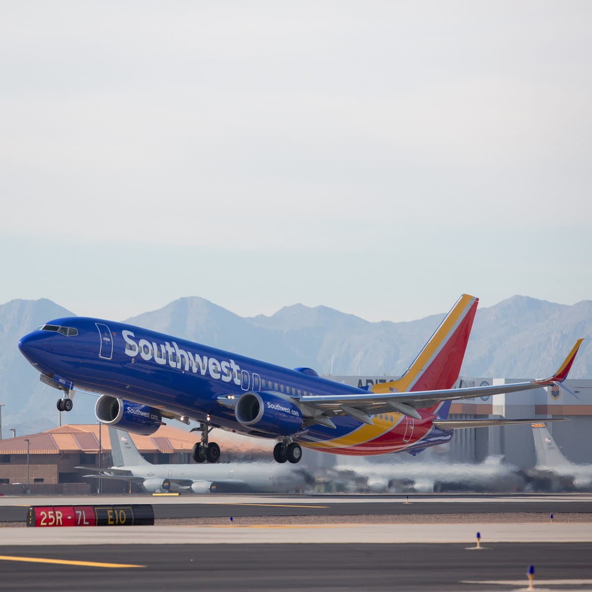 A southwest airplane taking off from a runway.