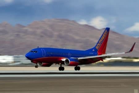 A southwest airlines jet takes off from the runway.