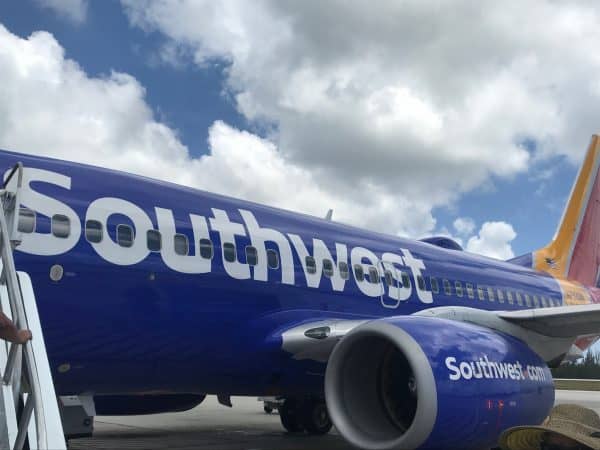 A man standing southwest airplane tarmac.