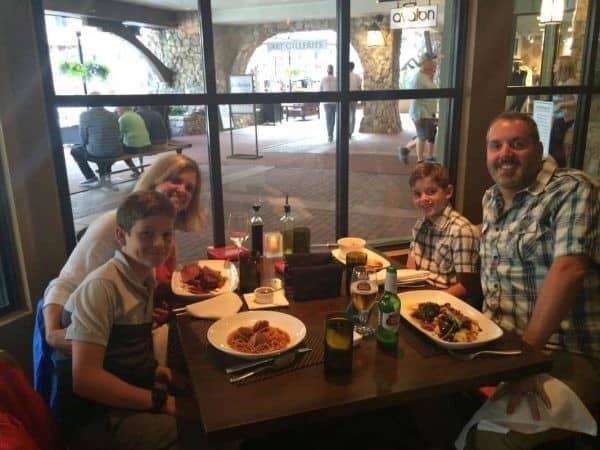 A family enjoys the Rapid Rewards Dining experience with plates of food at their table.