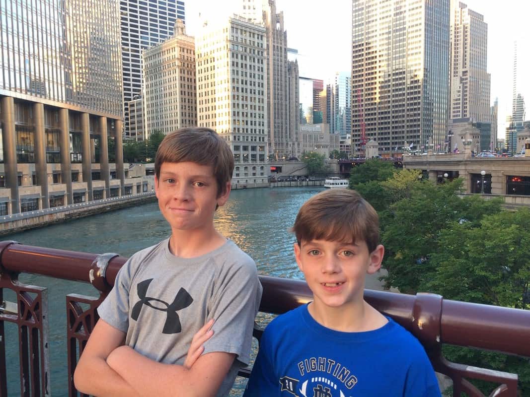 Boys on bridge with view of Chicago River in background