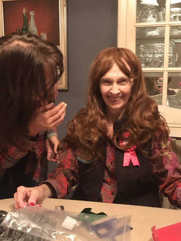 Two women are sitting at a table and talking to each other.