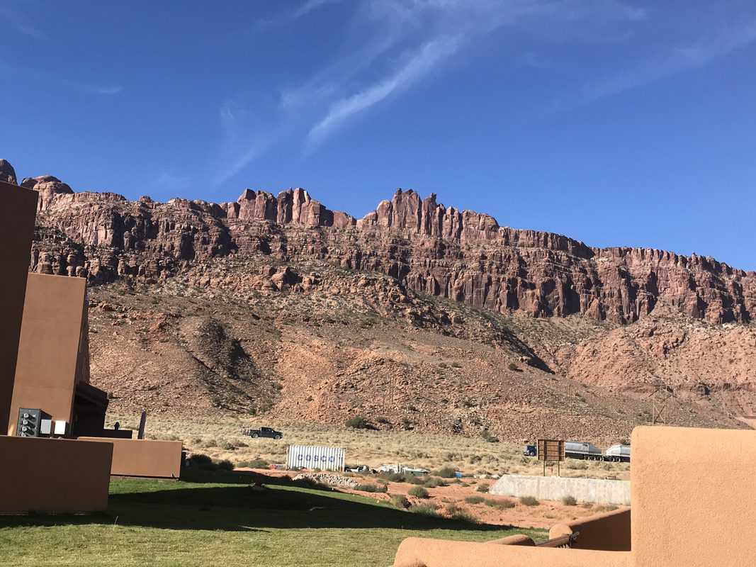 A view of the mountains from a building in the desert.