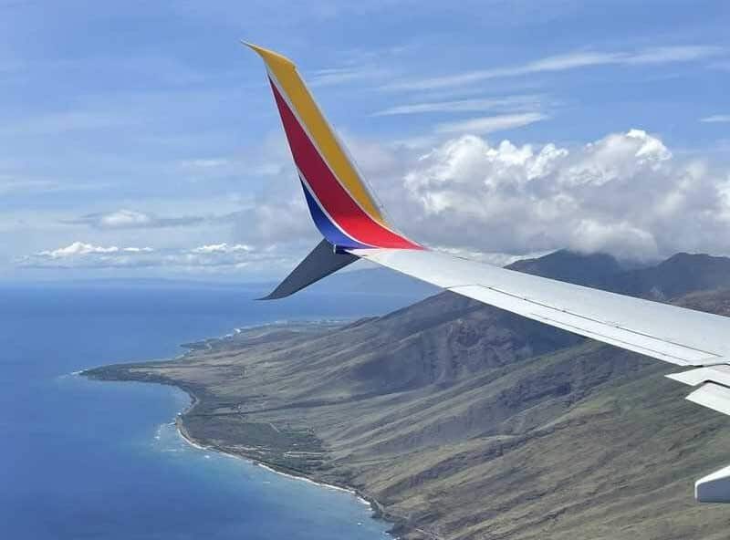 Flying airplane, ocean.