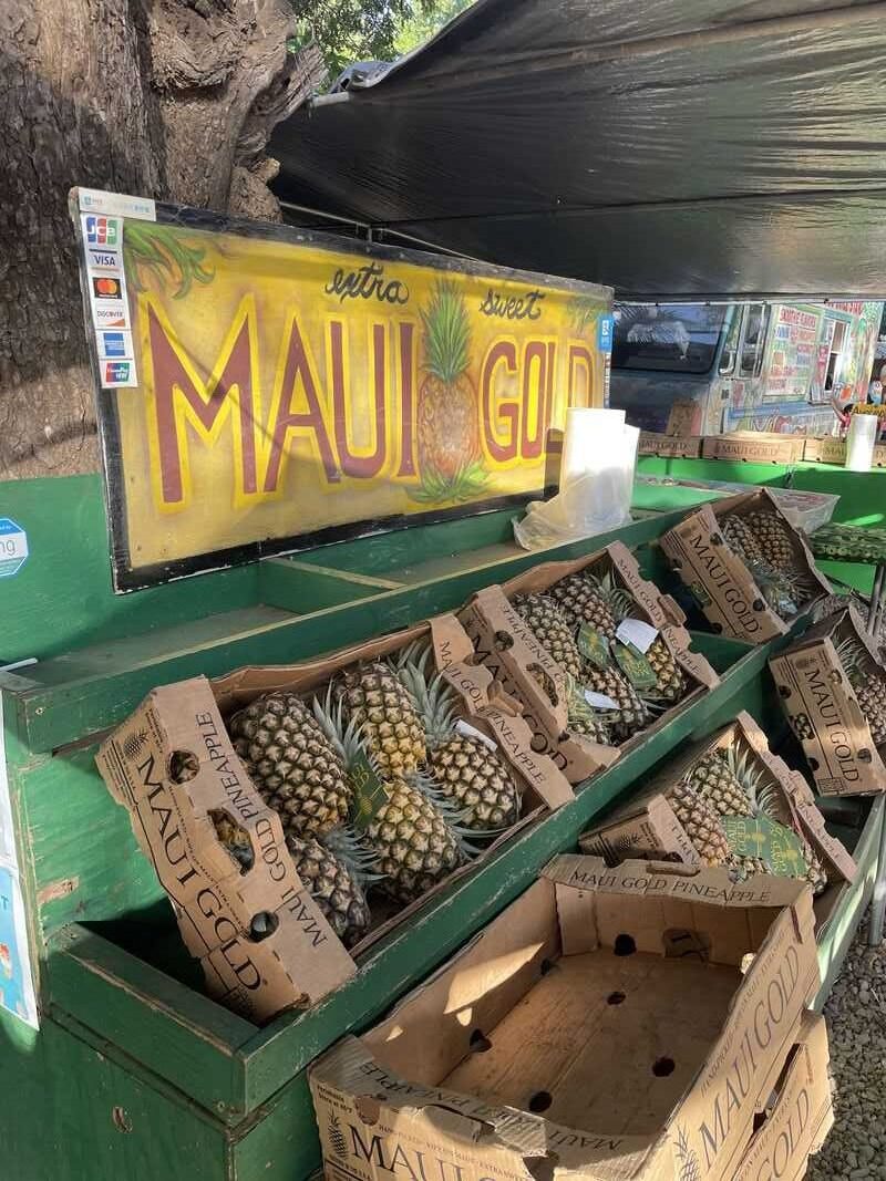 Pineapples are on display at a market in hawaii.