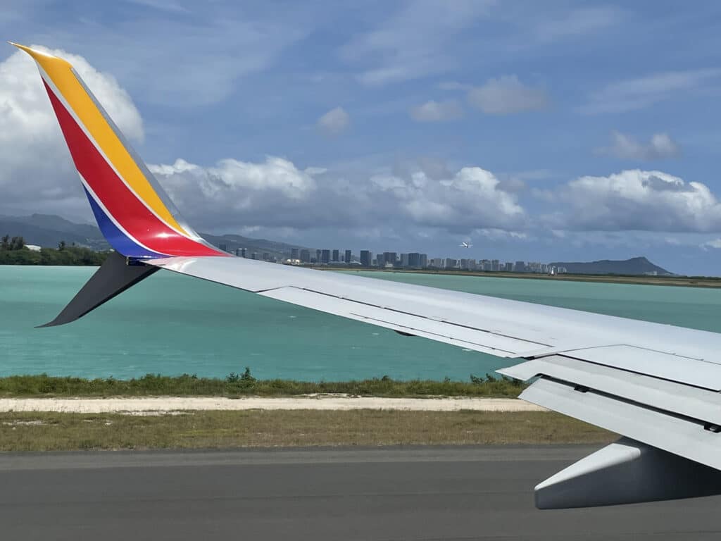 Southwest plane at Oahu airport with Diamondhead in background, Hawaii