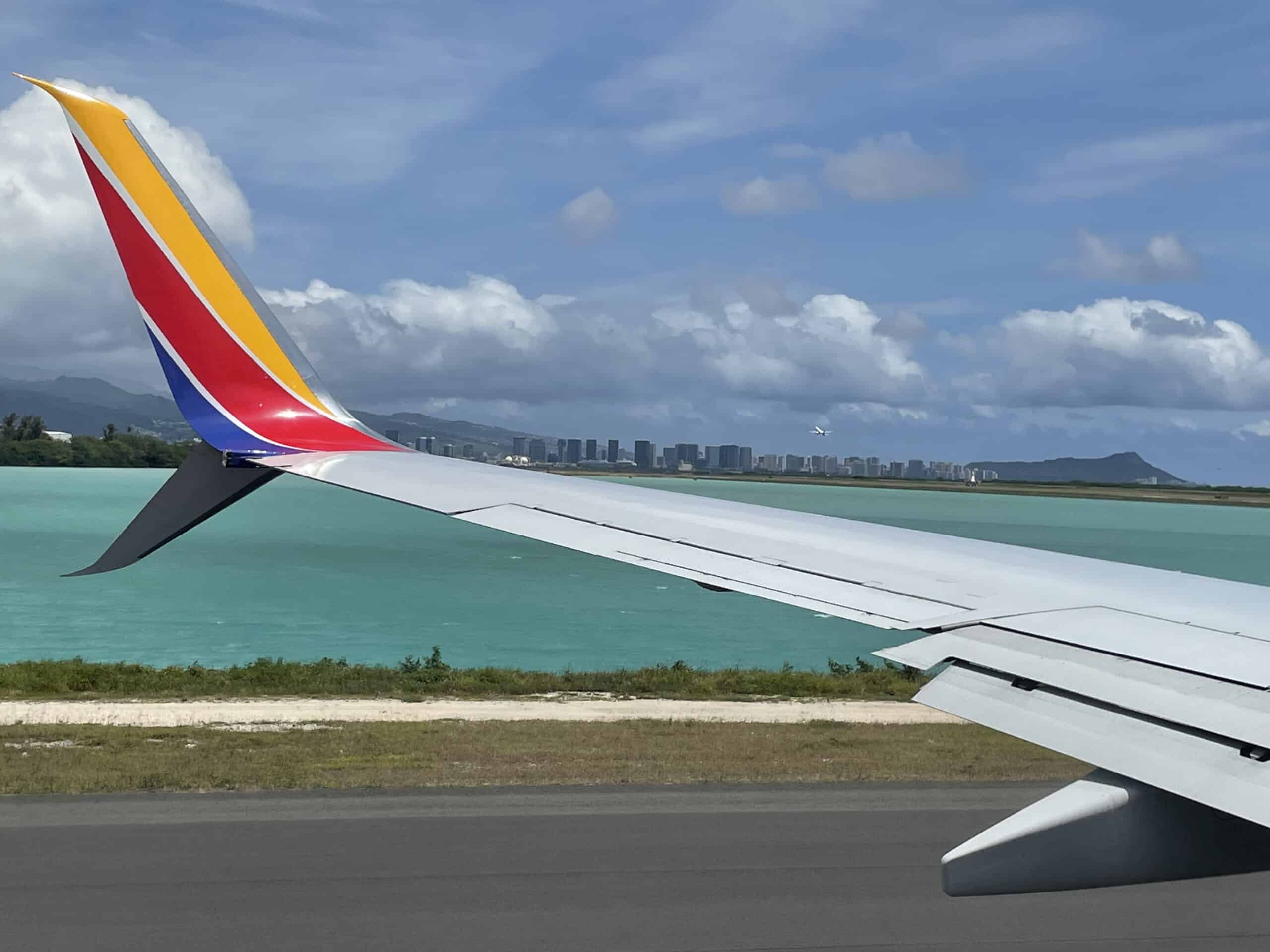 Southwest plane at Oahu airport with Diamondhead in background, Hawaii