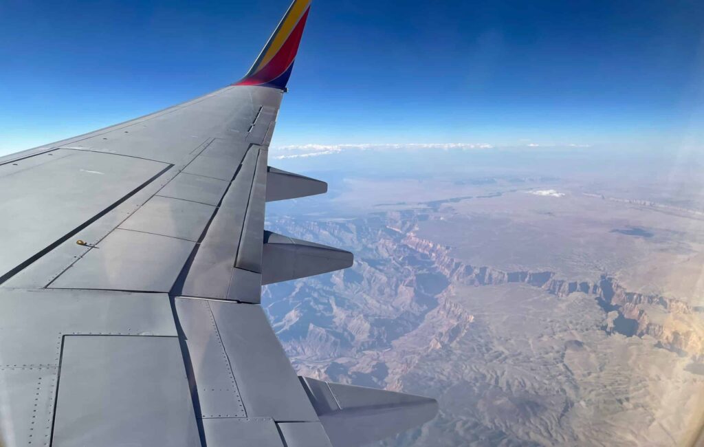 Southwest plane wingtip flying over canyons